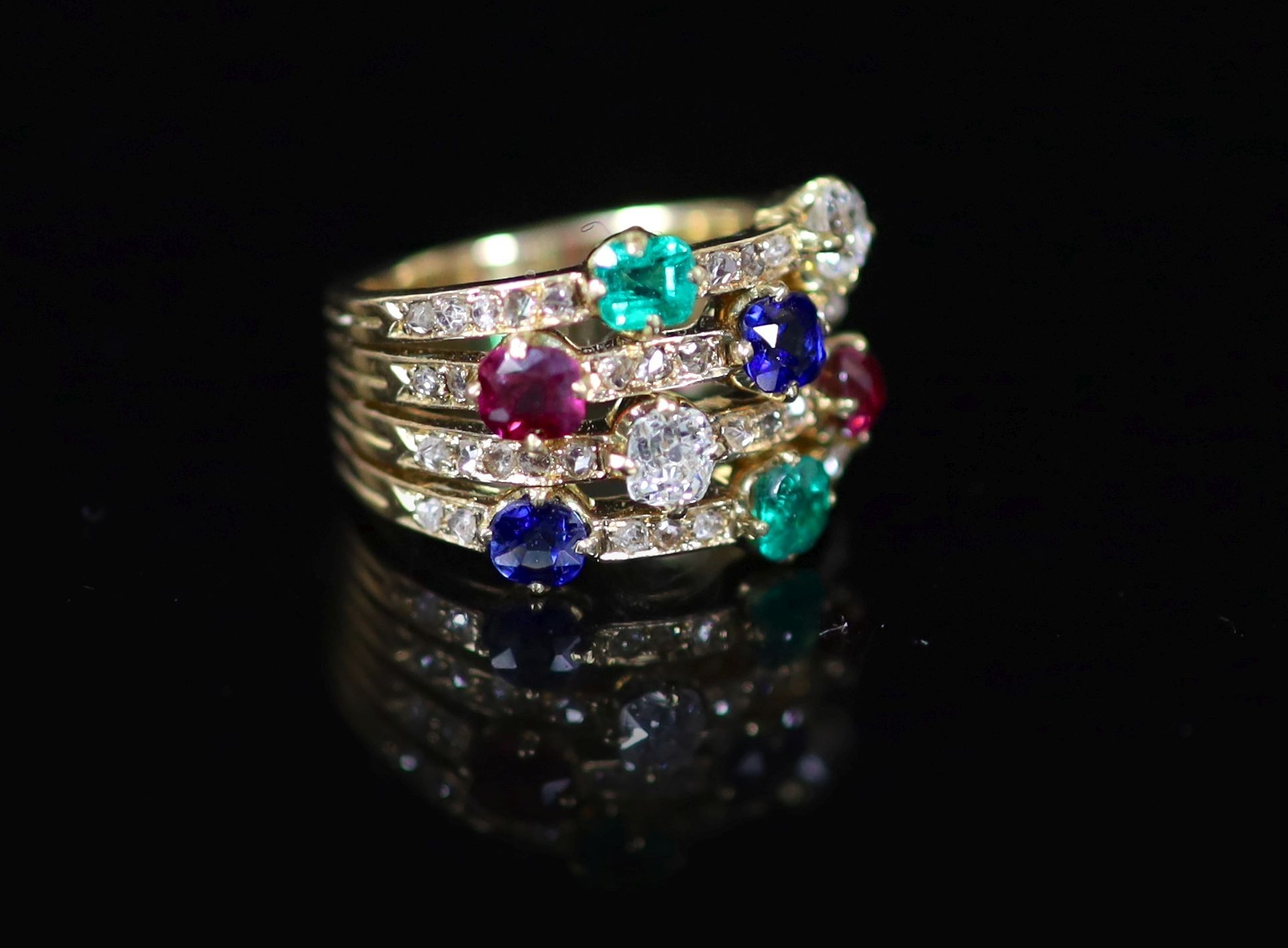A gold, emerald, ruby, sapphire and diamond set quadruple shank dress ring